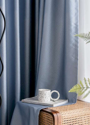 a coffee cup sitting on top of a table next to a window