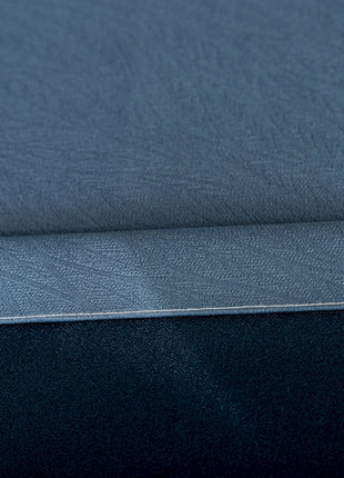 a close up of a blue sheet on a bed