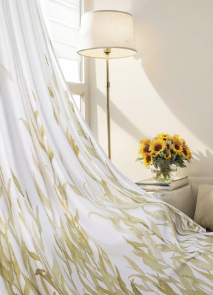 sunflowers in a vase on a table in front of a curtain