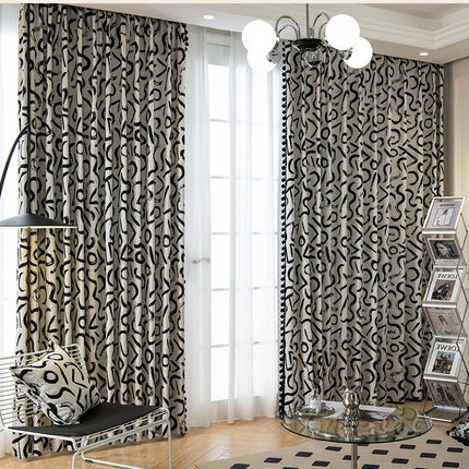 a living room with a black and white patterned curtain