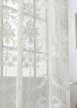 a white sheer curtain with a floral design