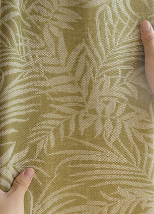 a person is pulling up a curtain with their hands