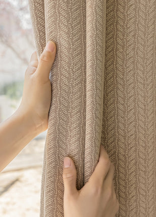 a person is opening a curtain with their hand