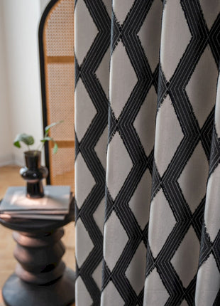 a black and white checkered curtain next to a chair