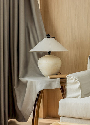 a white couch sitting next to a lamp on a table