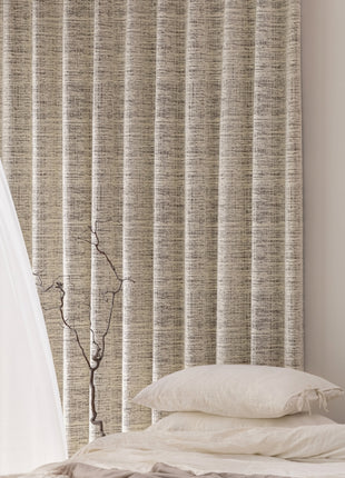 a bed with a white comforter and pillows