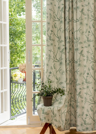 a chair sitting in front of a window next to a potted plant