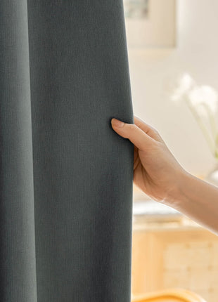 a person holding a curtain with their hand