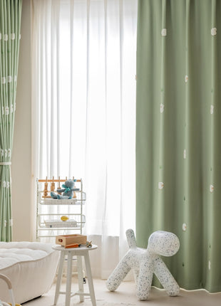 a child's room with green curtains and a white teddy bear