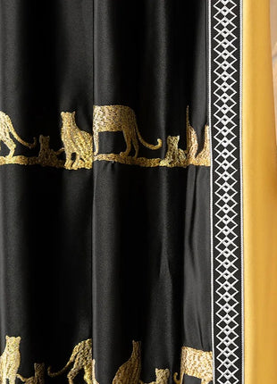 a curtain with a black and gold design