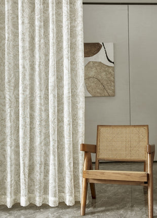 a chair sitting in front of a white curtain