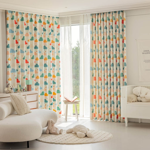 a baby's room with colorful curtains and a white crib