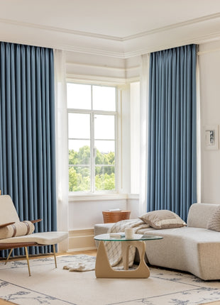 a living room filled with furniture and a large window