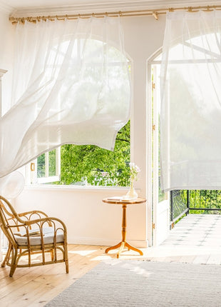 a living room with a chair and a window