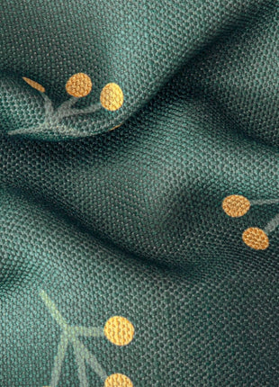 a close up of a green fabric with gold dots
