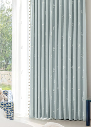 a teddy bear sitting in a chair next to a window