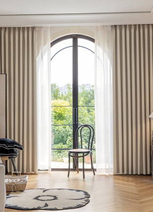 a living room filled with furniture and a large window