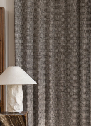 a lamp sitting on top of a table next to a window