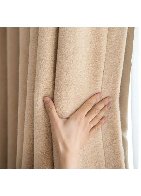 a person's hand on the curtain of a window