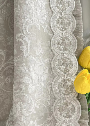 a bouquet of yellow tulips sitting on top of a curtain