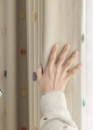 a person's hand on a curtain rod