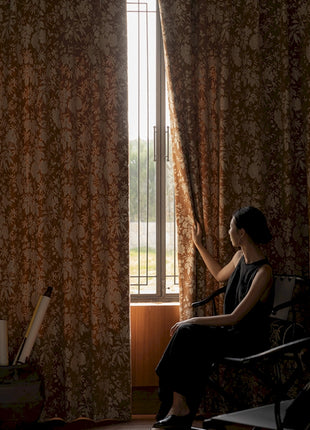 a woman sitting in a chair in front of a window