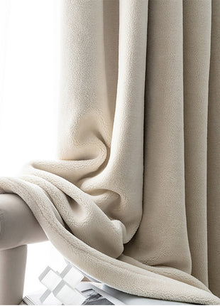 a close up of a curtain with a blanket on it