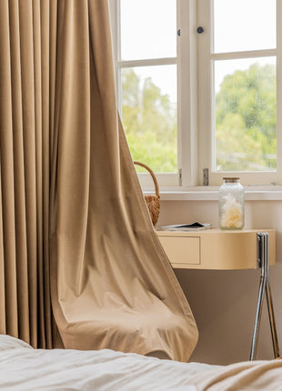 a bedroom with a bed, desk and a window