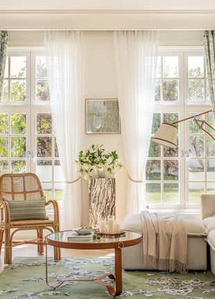 a living room filled with furniture and a large window