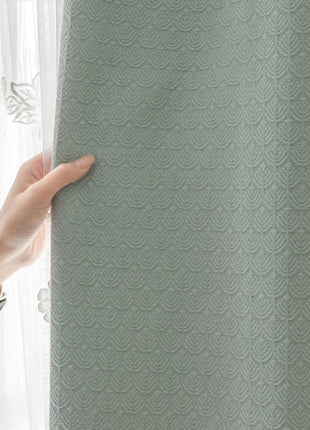 a person holding onto a curtain in front of a window