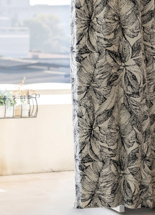 a curtain with a black and white flower pattern