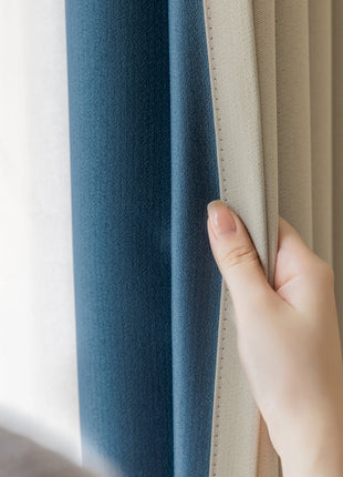 a person holding a curtain with their hand