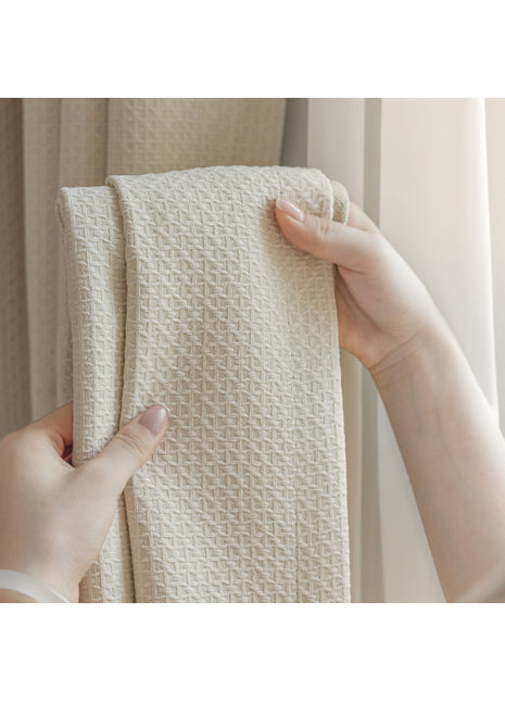 a person holding a white towel in front of a window
