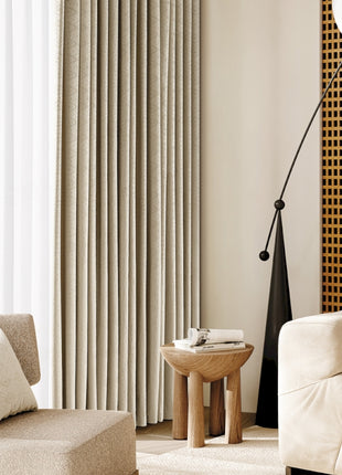 a living room with a white couch and a chair