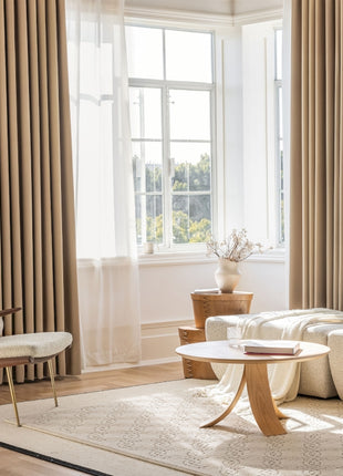 a living room filled with furniture and a large window