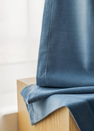 a close up of a blue curtain on a window sill