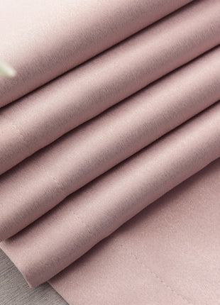 a close up of a pink sheet on a table