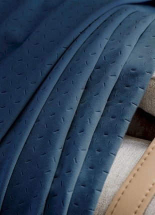 a close up of a bed with a blue blanket