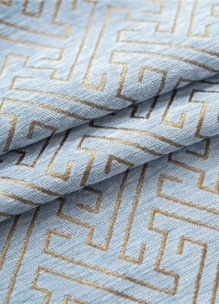 a close up of a blue and gold patterned fabric