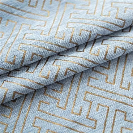 a close up of a blue and gold patterned fabric