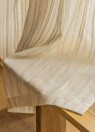 a close up of a wooden table with a curtain