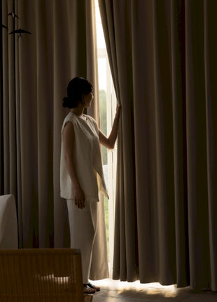 a woman standing in front of a window