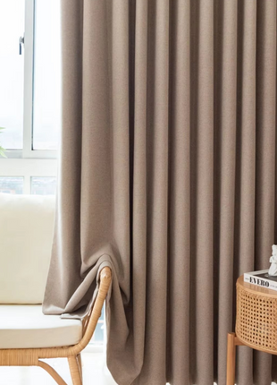 a living room with a chair and a window