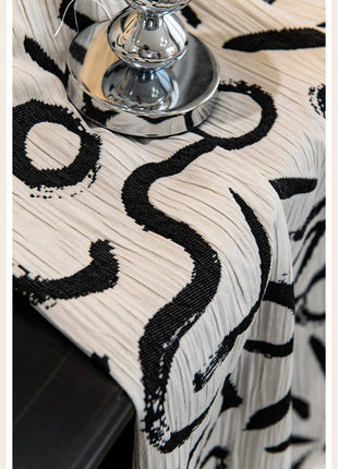 a table with a black and white table cloth on it