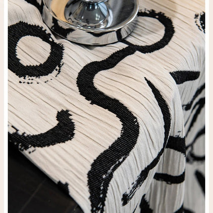 a table with a black and white table cloth on it