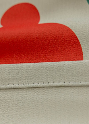a close up of a fabric with a red heart on it