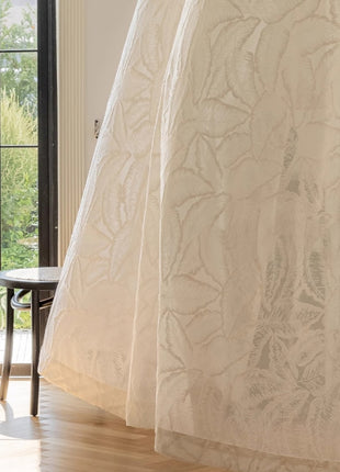 a cat sitting on a chair in front of a window