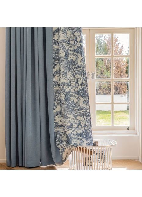 a window with a curtain and a basket in front of it