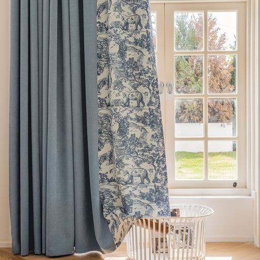 a window with a curtain and a basket in front of it