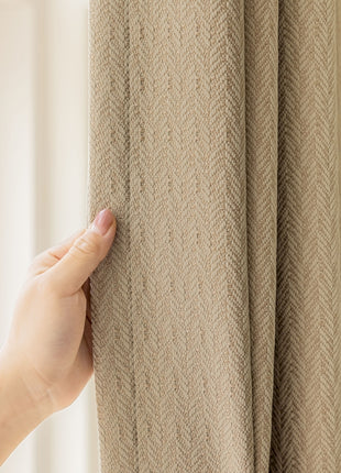 a hand is holding a curtain in front of a window